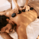 Relaxing hot stone massage therapy with warm stones and professional therapist